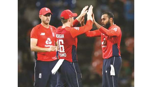 Englandu2019s Adil Rashid (right) celebrates with captain Eoin Morgan (centre) and Olly Stone after taking the wicket of Sri Lankau2019s Dasun Shanaka (not pictured). (Reuters)