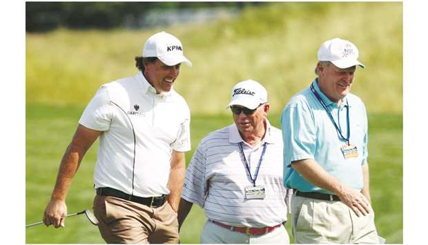 In this June 17, 2009, picture, former golfer Johnny Miller (right) walks with US player Phil Mickelson (left) and latteru2019s coach Butch Harmon during a practice round for the US Open golf at Bethpage State Park in Farmingdale, New York. (Reuters)