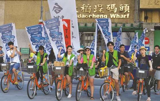 Pro-Taiwan independence activists riding bicycles with flags to promote a referendum on the streets in Taipei. Taiwan independence campaigners will take to the streets October 20 for what they hope will be a major rally in a rebuke to Beijing and a challenge to the islandu2019s already embattled government.