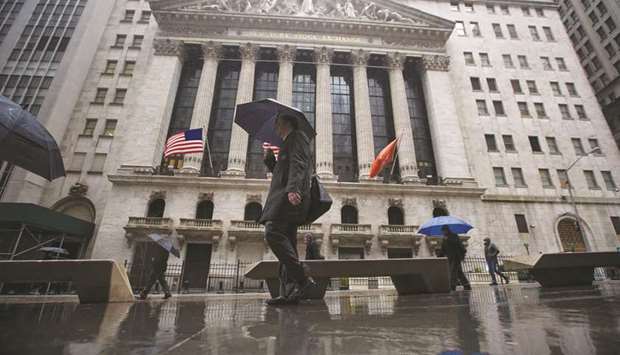 Pedestrians walking past the New York Stock Exchange building (file). Revenue from bond trading across Wall Street has fallen 40% since 2010, according to data provided by Oppenheimer analyst Chris Kotowski.