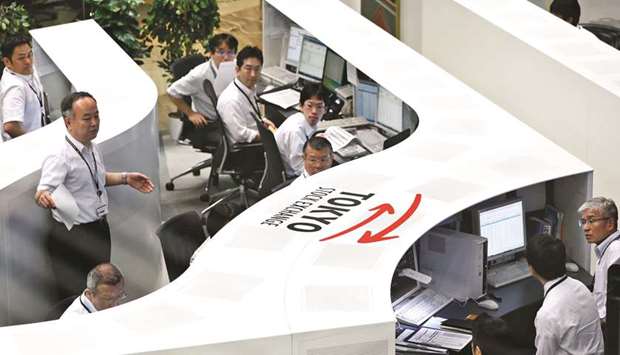 Employees work at the Tokyo Stock Exchange (file). The Nikkei 225 closed up 1.3% to 22,841.12 points yesterday.
