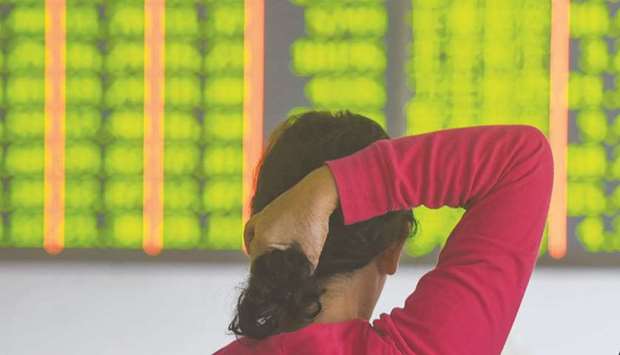 An investor monitors stock prices at a securities company in Hangzhou, Zhejiang province. Shares in Shanghai exchange plunged 2.9% to 2,486.42 points yesterday as the yuan weakened and the Federal Reserve flagged more US interest rate hikes.