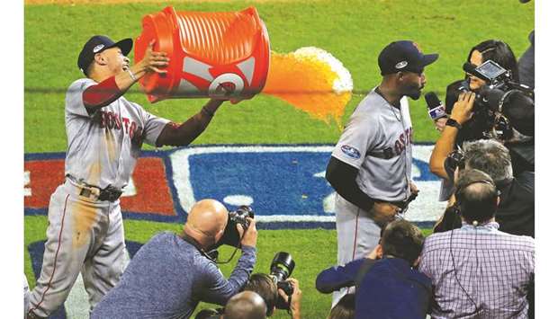 Boston Red Sox right fielder Mookie Betts (left) douses center fielder Jackie Bradley Jr. with a sports drink after defeating the Houston Astros in game three of the 2018 ALCS playoff baseball series in Houston, Texas, on Wednesday. (USA TODAY Sports)