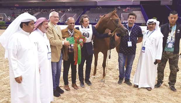 Al Shaqabu2019s Breeding and Show manager Sheikh Hamad bin Ali al-Thani (fourth from left), Qatar Racing and Equestrian Club (QREC) Board member Khalid bin Mohamed al-Ali (left) and QREC Racing manager Abdulla bin Rashid al-Kubaisi (second from right) pose with Hagras Al Shaqab after he won the class for two-year-old colts at the Morocco International Horse Show in El Jadida, Morocco, yesterday.