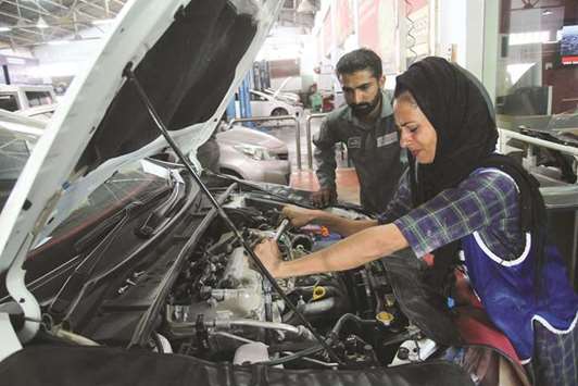 In this picture taken on September 1, Uzma Nawaz, 24, fixes a car at an auto workshop in Multan.