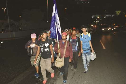 Honduran migrants taking part in a caravan to the United States arrive in Guatemala City late on Wednesday.