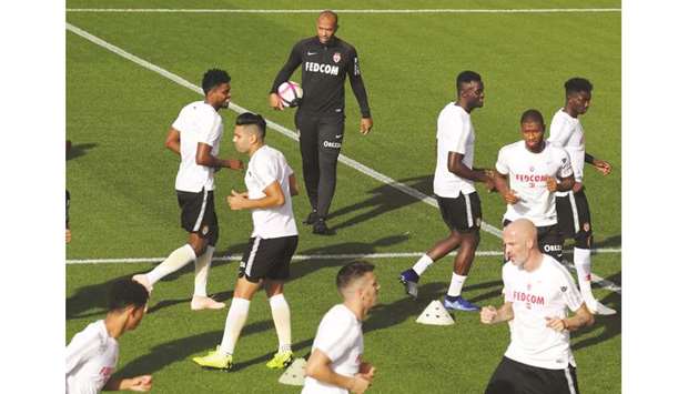 Monacou2019s French coach Thierry Henry (centre) walks past his players during a training session in La Turbie, near Monaco, yesterday. (AFP)