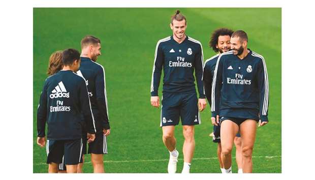 Real Madridu2019s Gareth Bale (centre), Marcelo and Karim Benzema (right) attend a training session at the Valdebebas training ground in Madrid yesterday.  (AFP)