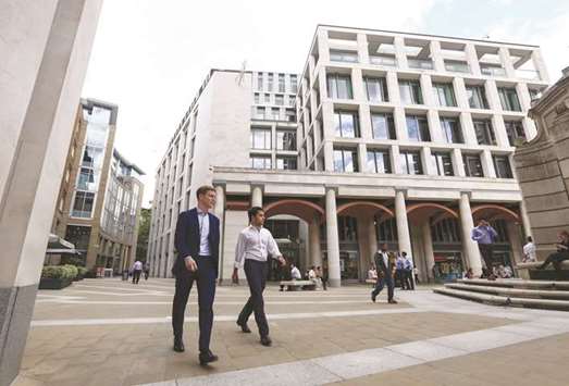 Pedestrians pass the London Stock Exchange building in Paternoster Square in London. The LSE tightened its grip on derivatives clearing yesterday in a sign of growing confidence that the threat of losing chunks of business to European Union rivals after Brexit was receding.