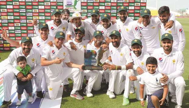 Pakistan cricket team celebrates with the winnersu2019 trophy after they beat Australia in the second Test match in Abu Dhabi by 373 runs to win the series 1-0. (AFP)