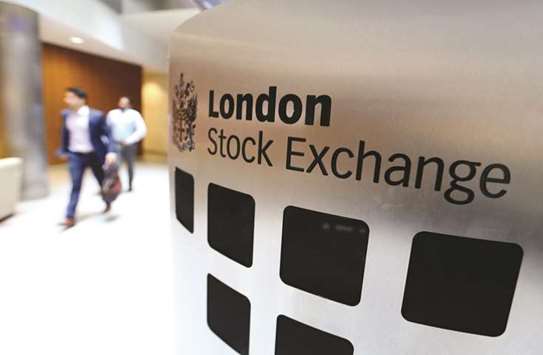 Visitors pass a sign inside the main atrium of the London Stock Exchange Group headquarters. The FTSE 100 closed 0.3% up at 7,049.80 points yesterday.