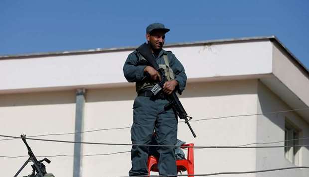 An Afghan policeman keeps watch at a polling station in Kabul, Afghanistan
