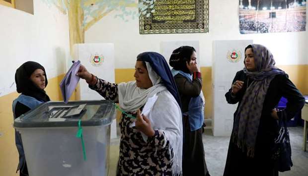 An Afghan woman casts her vote during parliamentary elections at a polling station in Kabul, Afghanistan.
