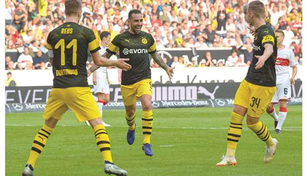 Dortmundu2019s Paco Alcacer (centre) celebrates with Marco Reus (left) and Jacob Bruun Larsen after scoring against VfB Stuttgart. (AFP)