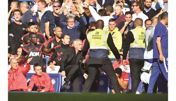 Manchester United manager Jose Mourinho (centre) reacts Chelsea assistant coach Marco Ianni (unseen) ran in front of the Portuguese to celebrate after the hosts scored the equaliser. (Reuters)