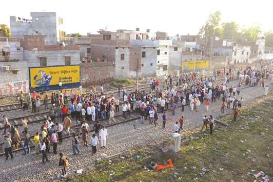 Angry relatives stage a protest at the scene of the train accident in Amritsar, yesterday.