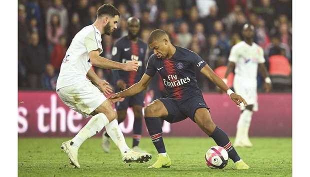 Paris Saint-Germainu2019s Kylian Mbappe (right) vies for the ball with Amiensu2019 Thomas Monconduit during the French Ligue 1 match in Paris yesterday. (AFP)