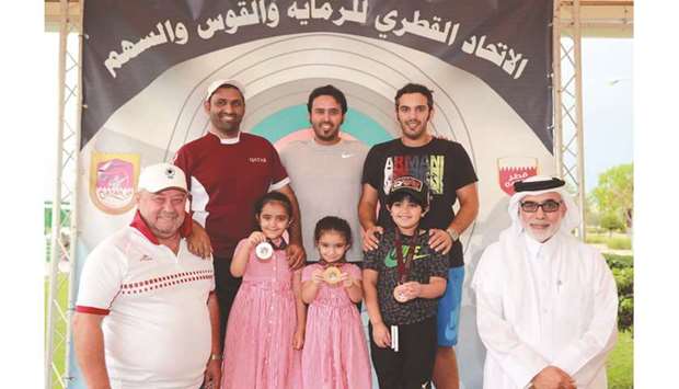 Menu2019s skeet winner Rashid al-Athba (rear, centre) poses with second-placed Mohamed al-Minkhas (rear, left) and third-placed Saeed Abu Sharb (rear, right) yesterday.