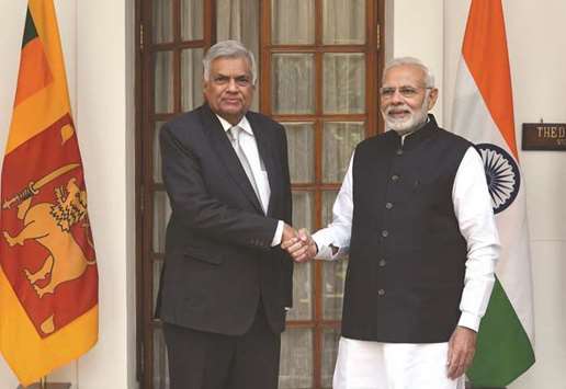 Indian Prime Minister Narendra Modi, right, shakes hands with his Sri Lankau2019s counterpart Ranil Wickremesinghe prior to a meeting in New Delhi yesterday.