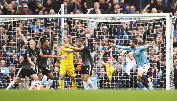 Manchester Cityu2019s Bernardo Silva (right) celebrates after scoring as Burnley players react yesterday. (Reuters)