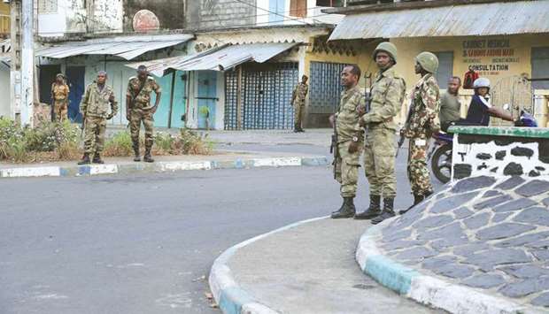 Soldiers from the Comoros armed forces station and wait outside the u201cmedina quarteru201d at Mutsamudu, in Anjouan.