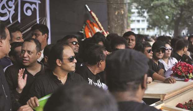 Musicians gather near the coffin of rock musician Ayyub Bachchu in Dhaka yesterday.