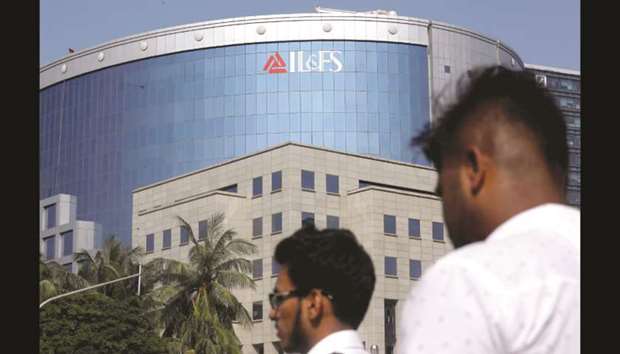 People walk past a building of Infrastructure Leasing and Financial Services in Mumbai. The Indian government has filed an application with the National Company Law Tribunal to remove the board of the company, warning the continuance of the current directors would be prejudicial and not in the interest of the public.