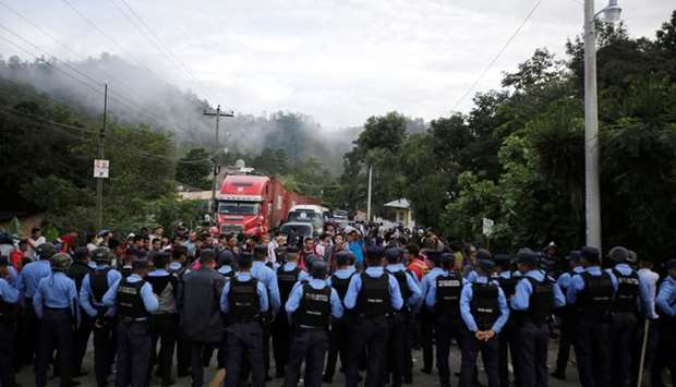 Honduran police officers block the access to the Agua Caliente border with Guatemala as Honduras' migrants try to join a migrant caravan heading to the US, in the municipality of Ocotepeque, Honduras.