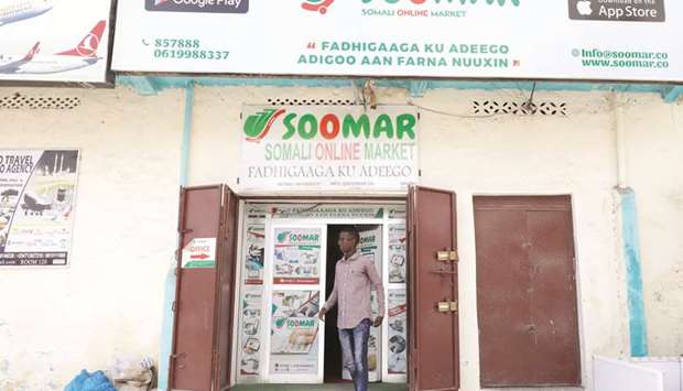 A customer walks out of the Somali Online Market (SOOMAR) offices at Maka Al Mukarama street in Mogadishu.
