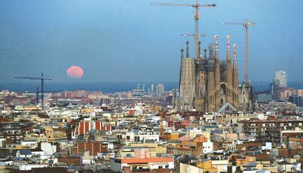 A u2018Super Blue Blood Moonu2019 rises behind Mediterranean sea, next to Sagrada Familia Basilica in Barcelona, in this picture taken early this year.