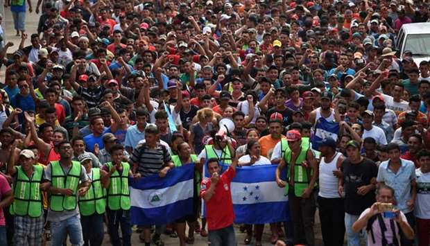 Honduran migrants heading in a caravan to the US, hold a demonstration demanding authorities to allow the rest of the group to cross, in Ciudad Hidalgo, Chiapas state, Mexico after crossing from Guatemala.