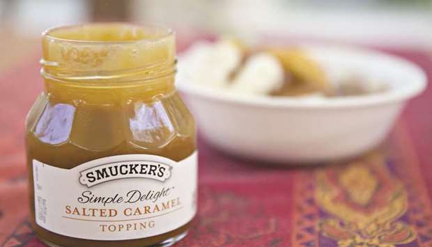 A jar of JM Smucker Cou2019s Smuckeru2019s Simple Delight brand salted caramel topping is arranged for a photograph in Tiskilwa, Illinois (file). In July, Smucker said it was selling its US baking unit, including Pillsbury, to Brynwood Partners to focus on innovation in segments such as coffee, peanut butter and snacks, many of which can be marketed as healthful. Other companies are working on similar moves, analysts say.