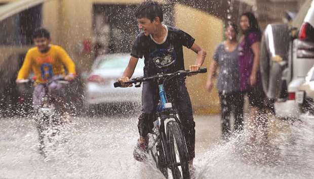 Kids enjoying the rain in Doha. PICTURE: Noushad Thekkayil