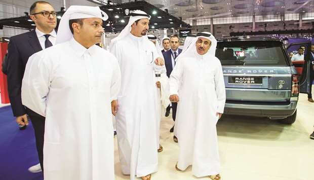 HE the Minister of Transport and Communications Jassim Seif Ahmed al-Sulaiti with Fahad Alfardan and others at the Alfardan Premier Motors stand at Qatar Motor Show.