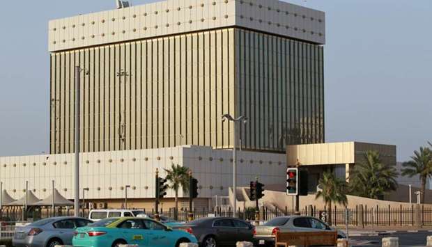 Cars drive past the building of the Qatar Central Bank in Doha (file). Qatar's fiscal balance is on track to return to a surplus for the first time since 2015 and remain in surplus next year, according to the IIF.