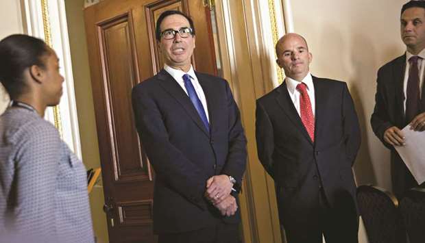 US Treasury Secretary Steven Mnuchin (second left) speaks to members of the media as Jose Antonio Gonzalez Anaya, Mexicou2019s finance minister (second right), listens after an event at the US Treasury in Washington, on October 17. Mnuchin yesterday acknowledged that u201cthere are obviously economic issuesu201d behind the renminbiu2019s weakness.