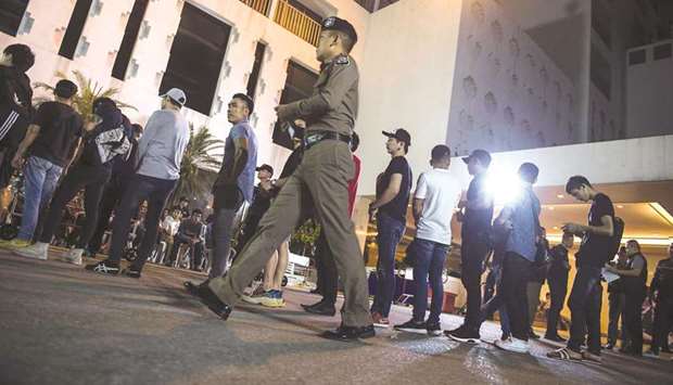 Police holding a group of men for mandatory drug testing in Bangkoku2019s Patpong district during a police operation called u201cX-Ray Outlaw Foreigneru201d.