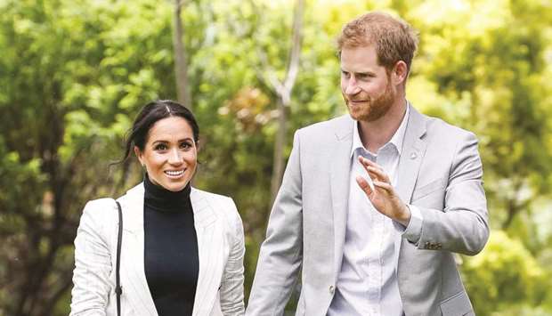Prince Harry and Meghan, Duchess of Sussex, hold hands while walking through Sydney Olympic Park, Australia, yesterday.