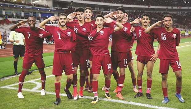 Qataru2019s goalscorers Abdulrasheed Umaru (left), Mohamed Waad Abdulwahhab (fourth from right) and Hashim Ali (right) celebrate with their teammates after their victory over Indonesia in their AFC U-19 Championship Group A match in Jakarta, Indonesia, yesterday. PICTURES: Fadi al-Asaad