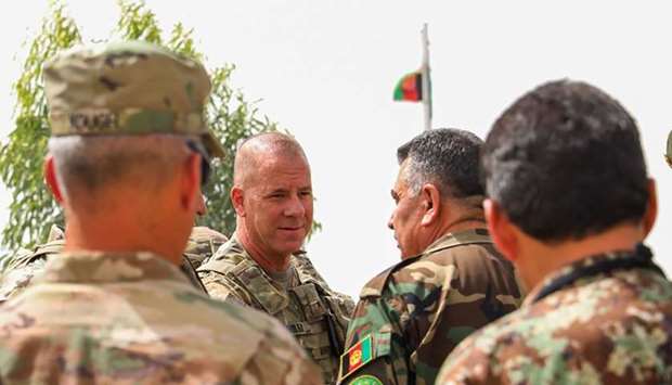 Brigadier General Jeffrey Smiley (2L), commanding general for Train, Advise and Assist Command-South talking with Afghan Army Brigadier General Abdul Rahman Parwani (2R), deputy commander of the 205th Corps Afghan army, in Kandahar on July 5, 2018. AFP/US Army/TAAC-South Public Affairs