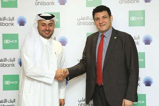 Al-Efrangi (left) with an NCR official at the agreement signing.