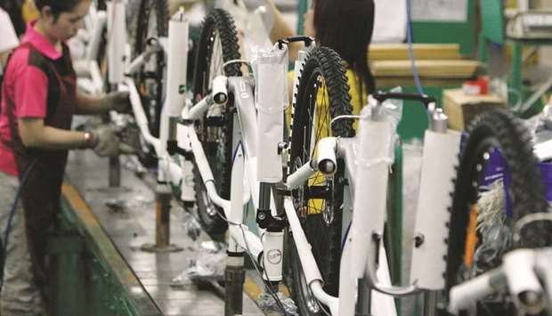 People work on the assembly line at the Giant bicycle factory in Taichung. Orders for trade-dependent Taiwan, which have seen steady single-digit growth since a small dip in June, rose 4.2% in September from a year earlier to $47.86bn, a record for that month, ministry of economic affairs data showed yesterday.