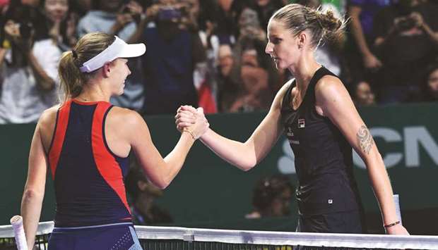 Czech Republicu2019s Karolina Pliskova (right) shakes hands with Denmarku2019s Caroline Wozniacki after winning their WTA Finals singles match in Singapore yesterday. (AFP)