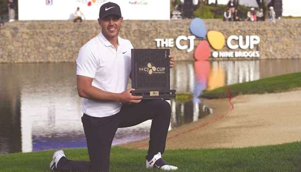 Brooks Koepka of the US poses with the trophy after winning the CJ Cup golf tournament at Nine Bridges golf club in Jeju Island yesterday. (AFP)