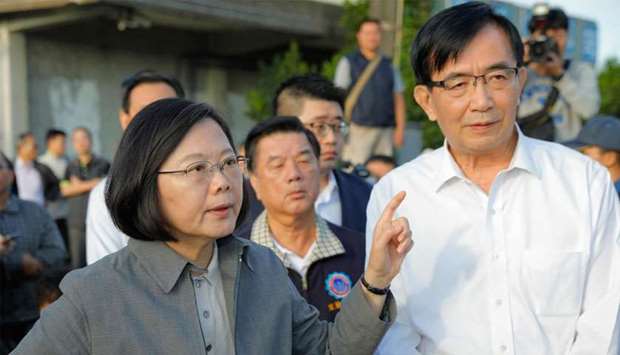 Taiwan's President Tsai Ing-wen (L) gestures during a briefing of a search and rescue team at Xinma station in Taiwan's northeastern Yilan county on October 22, 2018, a day after a Puyuma Express train derailed at high speed near the station.