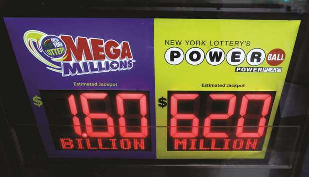 Signs display yesterday the jackpots for todayu2019s Mega Millions and tomorrowu2019s Powerball lottery drawings in New York City.