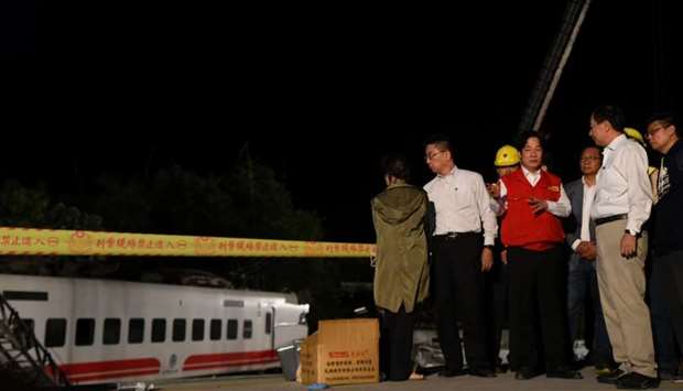 Taiwan's Premier William Lai (C) visits the site of derailed train, in Yilan,Taiwan Sunday