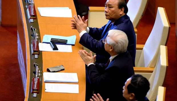 Vietnam's Prime Minister Nguyen Xuan Phuc (top) and Communist Party General Secretary Nguyen Phu Trong (2nd from top) attend the National Assembly opening its autumn session in Hanoi on yesterday.
