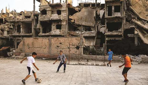 Children play soccer in Al-Khalidiya area, in the government-controlled part of Homs, Syria.
