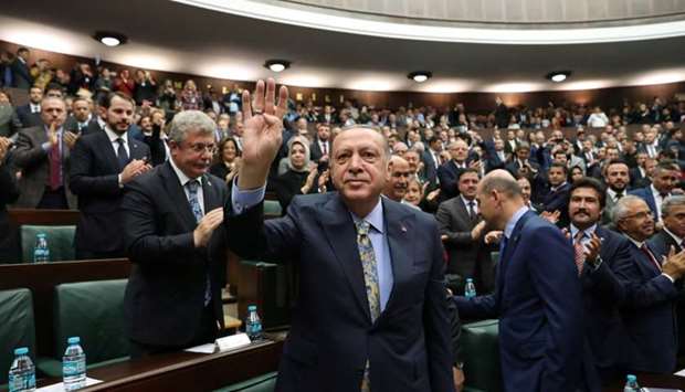 Turkish President Tayyip Erdogan greets members of parliament from his ruling AK Party (AKP) during a meeting at the Turkish parliament in Ankara.